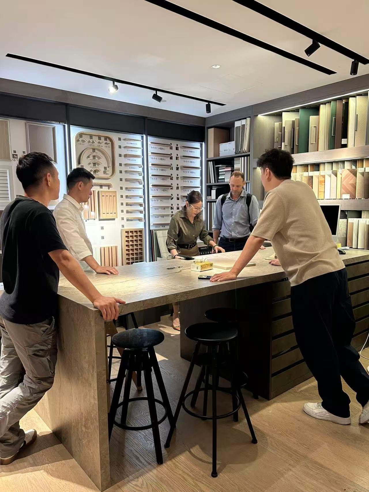 Clients reviewing BOCARNI kitchen drawings at showroom island